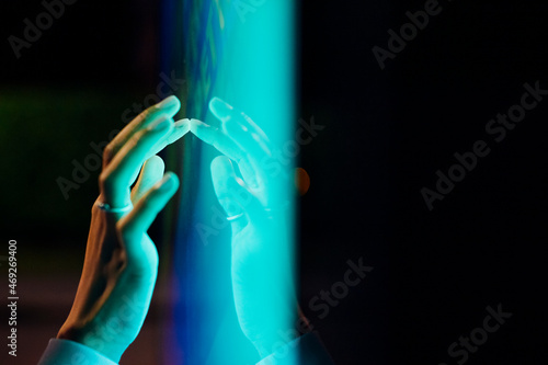 Woman touching kiosk screen at night