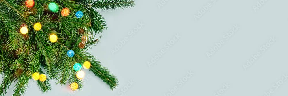Fir tree branches on blue backgrund. Top view.