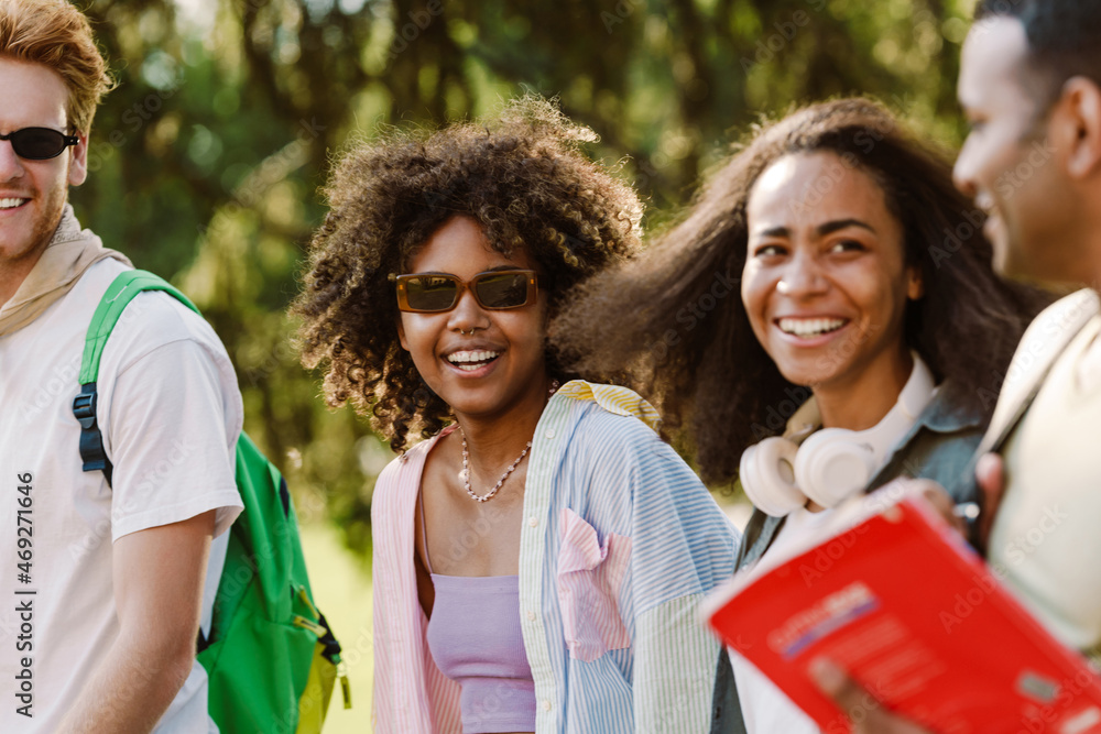 Multiracial students smiling and talking while walking