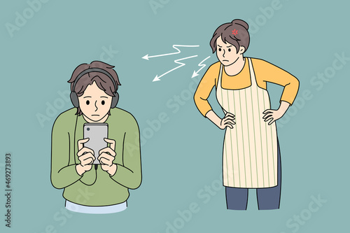 Angry mother scold lecture teen son on headphones using cellphone device. Mad furious mom swear teenage boy child overuse smartphone play online. Social media addiction. Vector illustration. 