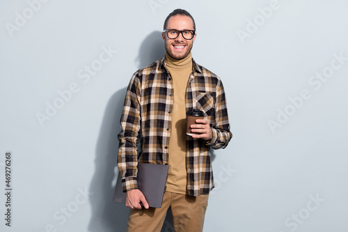 Photo of young guy drink latte espresso tea rest hold laptop agent isolated over grey color background