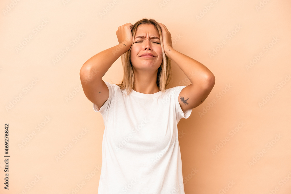Young caucasian woman isolated on beige background crying, unhappy with something, agony and confusion concept. Young caucasian woman isolated on beige background crying, unhappy with something, agony and confusion concept.
