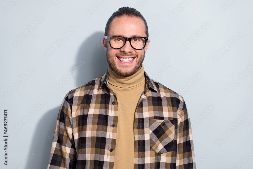 Photo of young handsome man good mood confident smart marketer eyewear isolated over grey color background Photo of young handsome man good mood confident smart marketer eyewear isolated over grey color background