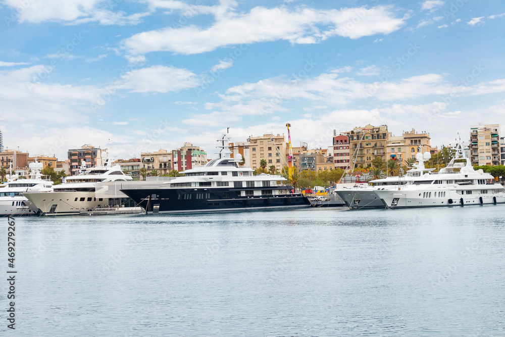 Luxury yachts in Port Vell harbor, on Barceloneta beach, Barcelona, Catalonia, Spain