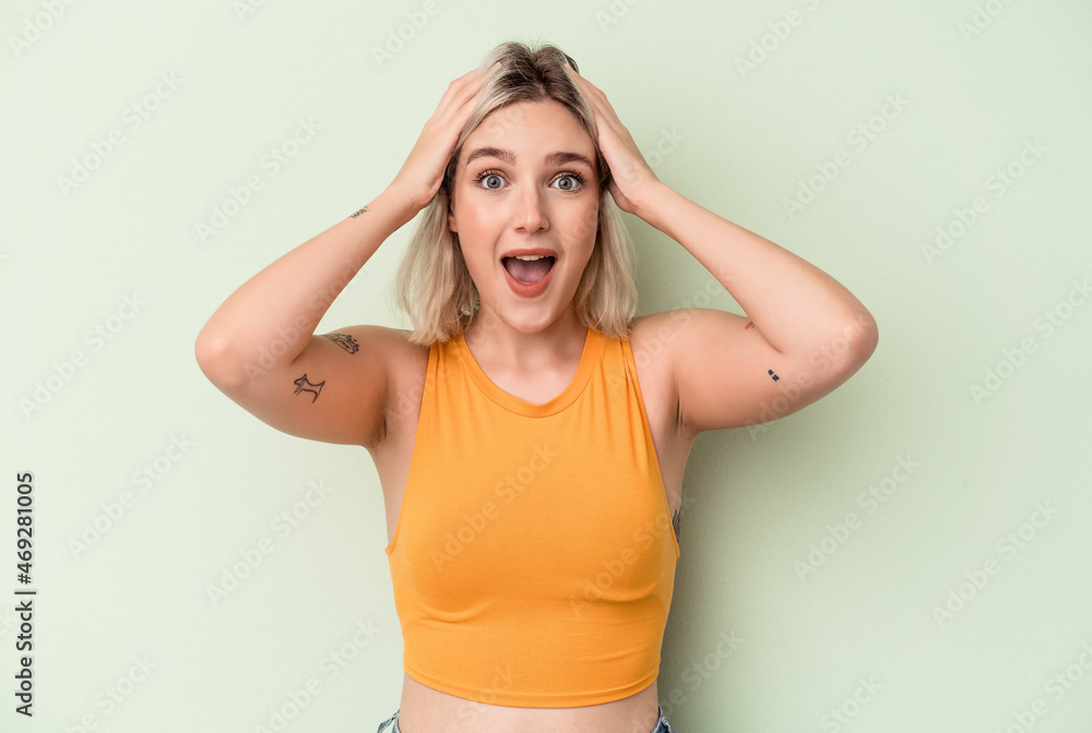 Young caucasian woman isolated on green background screaming, very excited, passionate, satisfied with something. Young caucasian woman isolated on green background screaming, very excited, passionate, satisfied with something.