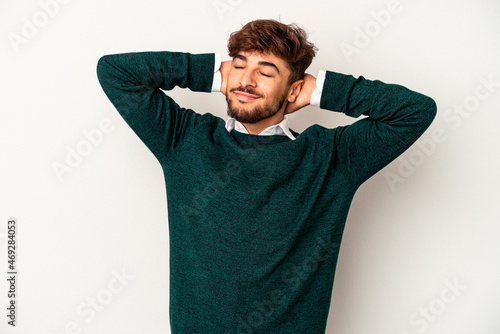 Young mixed race man isolated on grey background feeling confident, with hands behind the head.