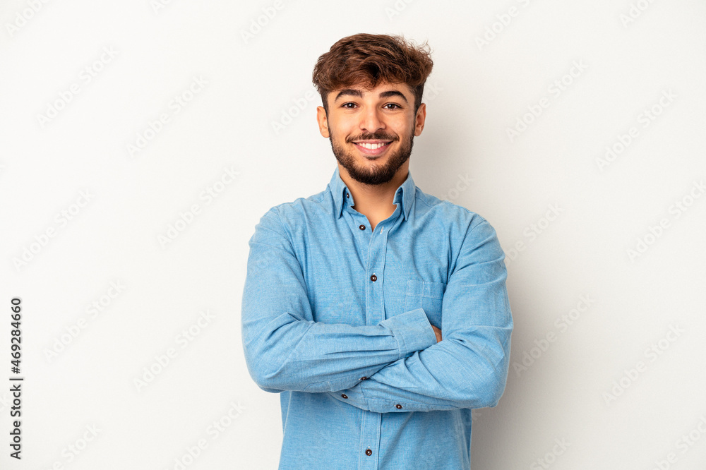 Young mixed race man isolated on grey background who feels confident, crossing arms with determination. Young mixed race man isolated on grey background who feels confident, crossing arms with determination.