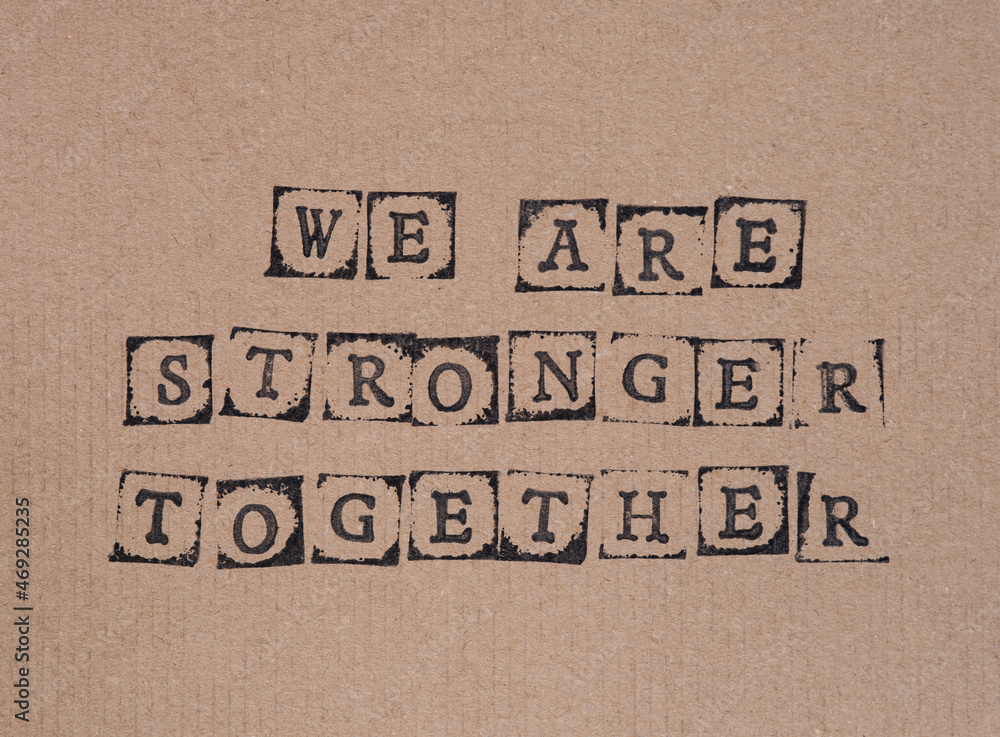 Cardboard with words We Are Stronger Together