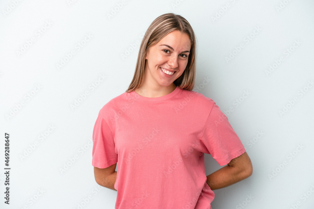 Fototapeta premium Young caucasian woman isolated on blue background happy, smiling and cheerful.