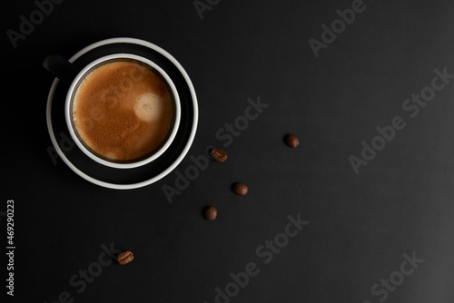 Cup of coffee on black background. Modern Lifestyle Flat-lay Top-down Minimalist Flat-lay. Top view. Copy space.