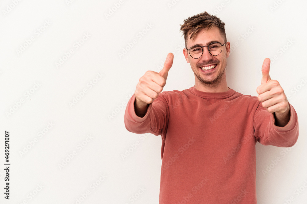 Young caucasian man isolated on white background smiling and raising thumb up Young caucasian man isolated on white background smiling and raising thumb up