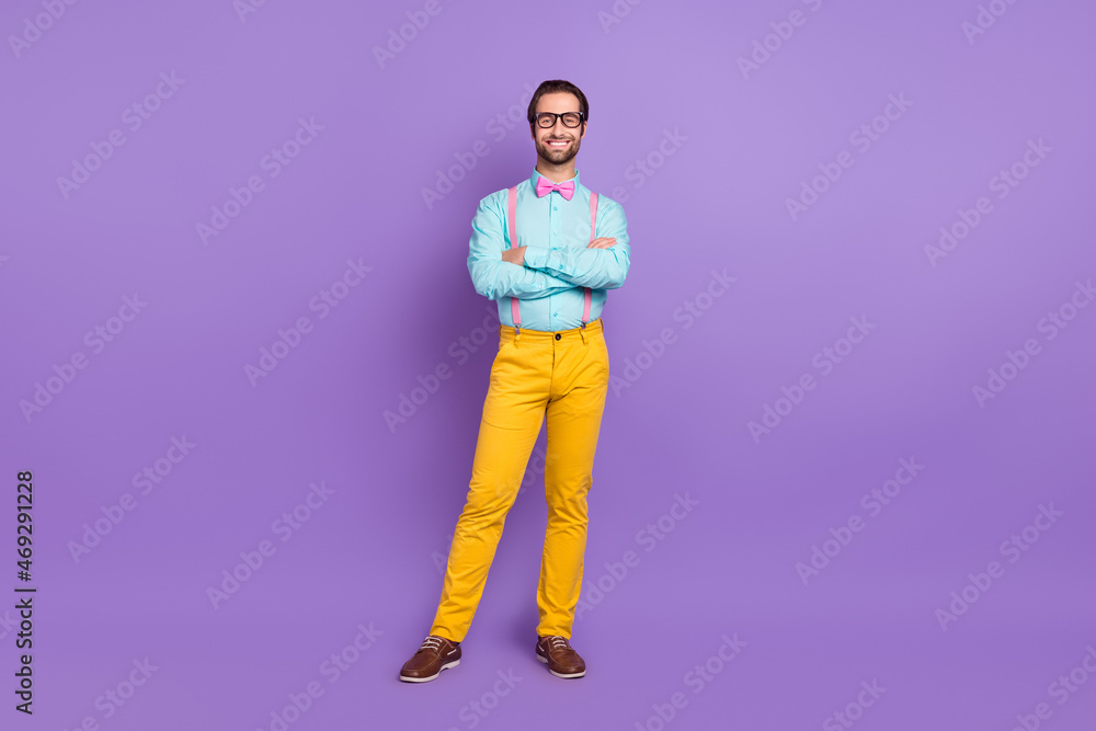 Fototapeta premium Full size photo of nice millennial hipster brunet man crossed arms wear tie suspenders shirt spectacles trousers sneakers isolated on violet background