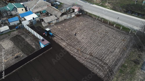 Wallpaper Mural blue tractor plows the land for harvest Torontodigital.ca