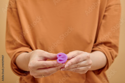 Close-up of young woman hands folding a menstrual cup.
Women health concept, zero waste alternatives