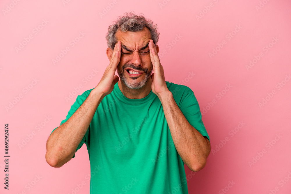 Middle age caucasian man isolated on pink background touching temples and having headache. Middle age caucasian man isolated on pink background touching temples and having headache.