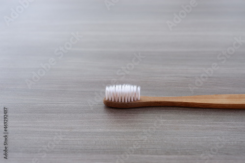 Close-up photo of a toothbrush against a wood texture background from various angles