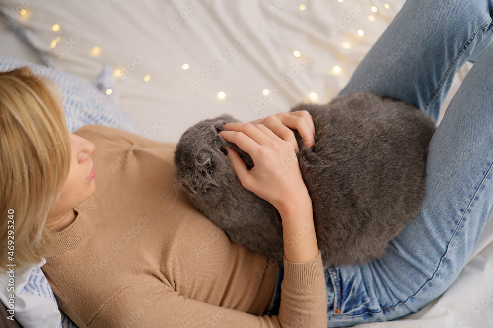 Pets, morning, comfort, rest and people concept - happy young woman with cat in bed at home Pets, morning, comfort, rest and people concept - happy young woman with cat in bed at home