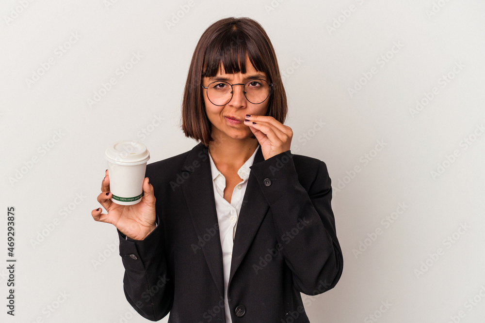 Young mixed race business woman holding a coffee isolated on white background with fingers on lips keeping a secret. Young mixed race business woman holding a coffee isolated on white background with fingers on lips keeping a secret.