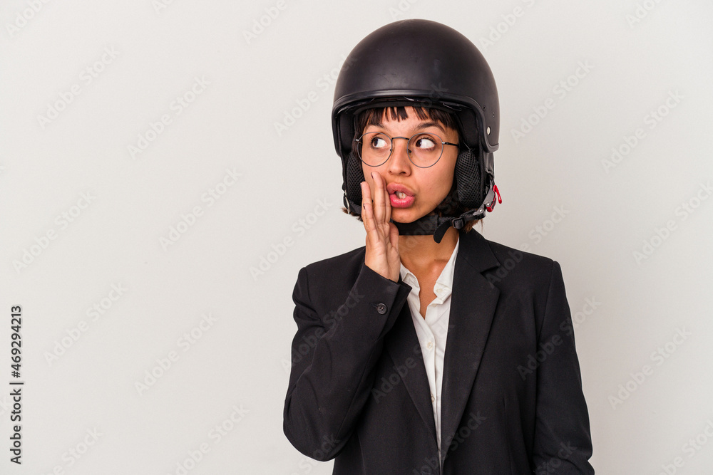 Young mixed race business woman wearing a motorbike helmet isolated is saying a secret hot braking news and looking aside Young mixed race business woman wearing a motorbike helmet isolated is saying a secret hot braking news and looking aside