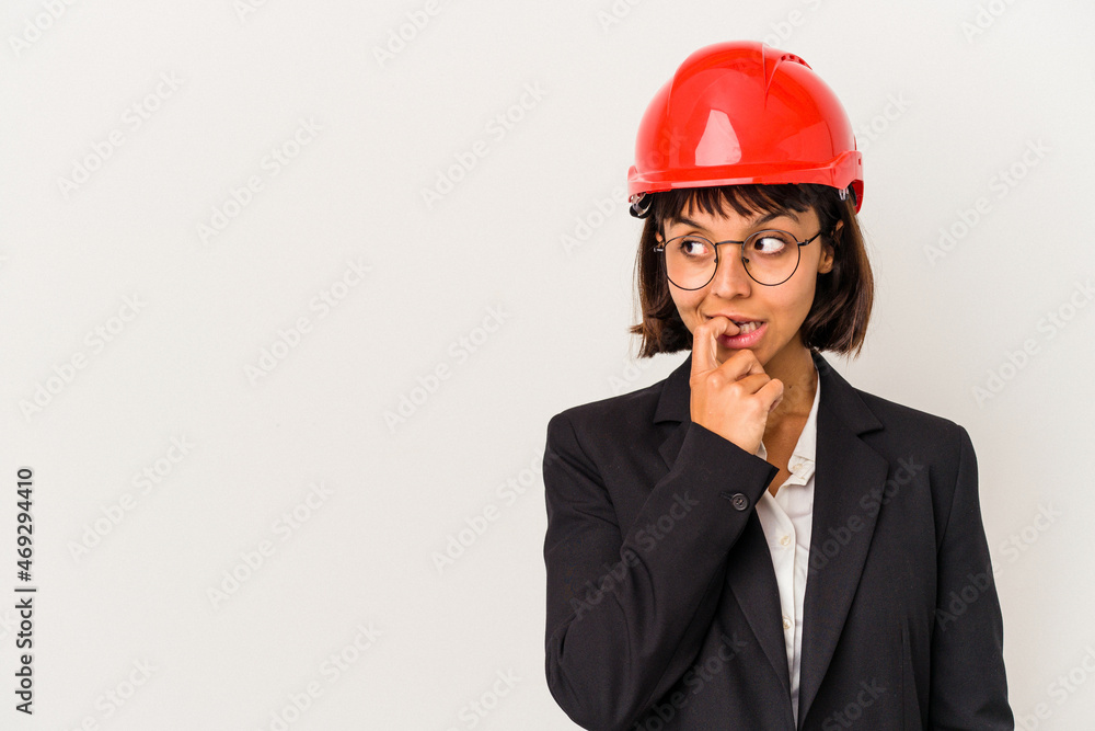 Young architect woman with red helmet isolated on white background relaxed thinking about something looking at a copy space. Young architect woman with red helmet isolated on white background relaxed thinking about something looking at a copy space.