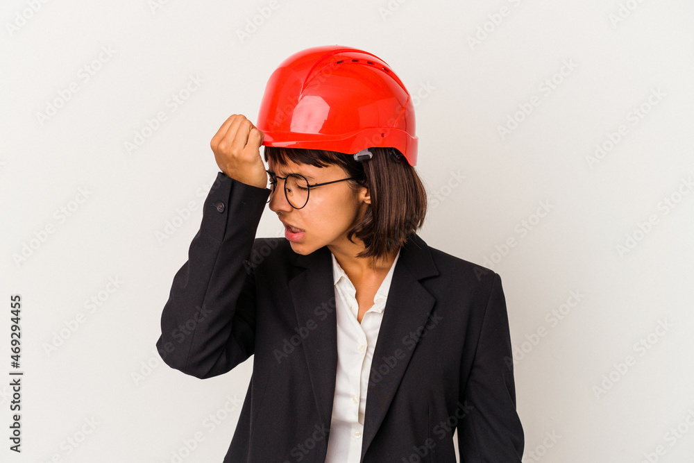 Young architect woman with red helmet isolated on white background forgetting something, slapping forehead with palm and closing eyes. Young architect woman with red helmet isolated on white background forgetting something, slapping forehead with palm and closing eyes.