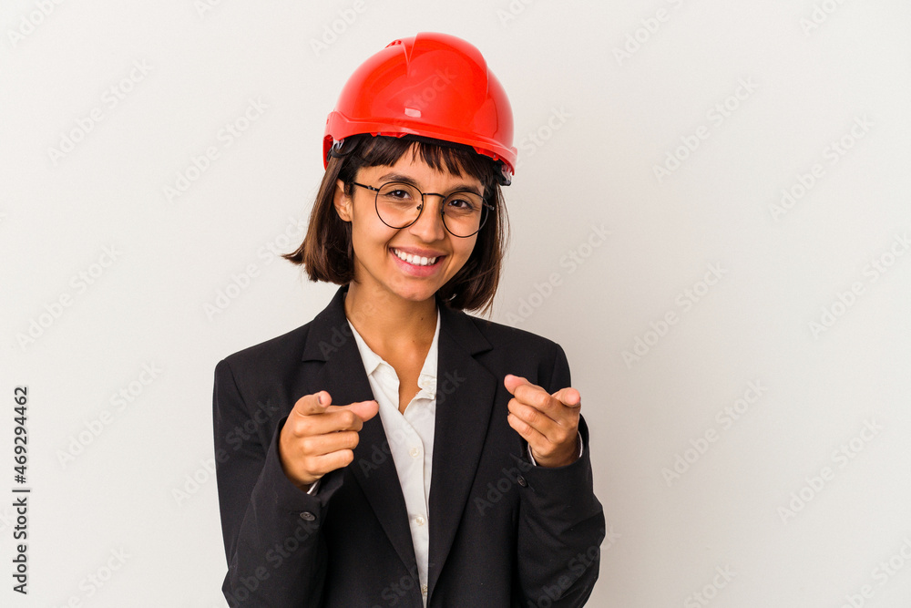 Young architect woman with red helmet isolated on white background cheerful smiles pointing to front. Young architect woman with red helmet isolated on white background cheerful smiles pointing to front.