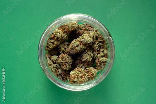 Photography Close up of cbd cannabis buds in glass jar, macro view