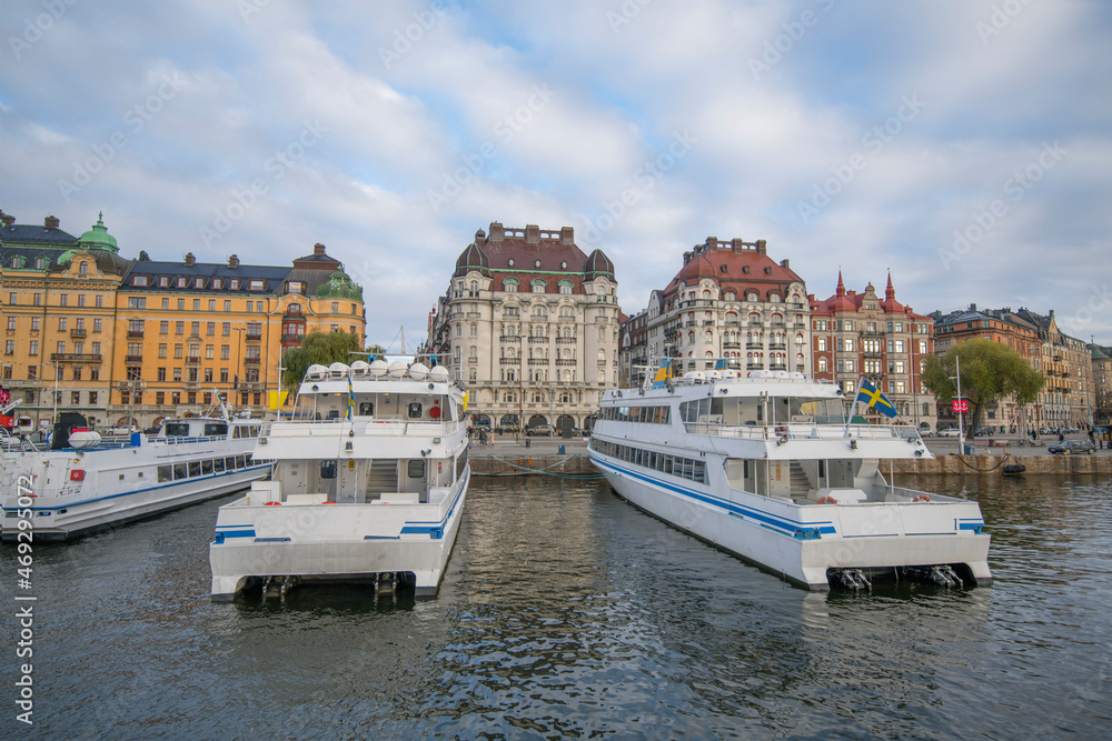 The pier Strandvägen at the bay Ladugårdsviken with commuting boats, hotels, offices and apartments an autumn day in Stockholm