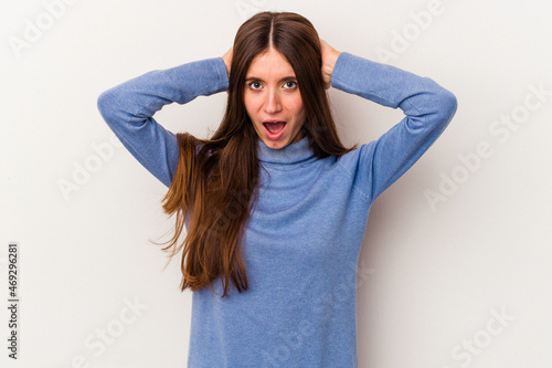 Young caucasian woman isolated on white background screaming, very excited, passionate, satisfied with something.