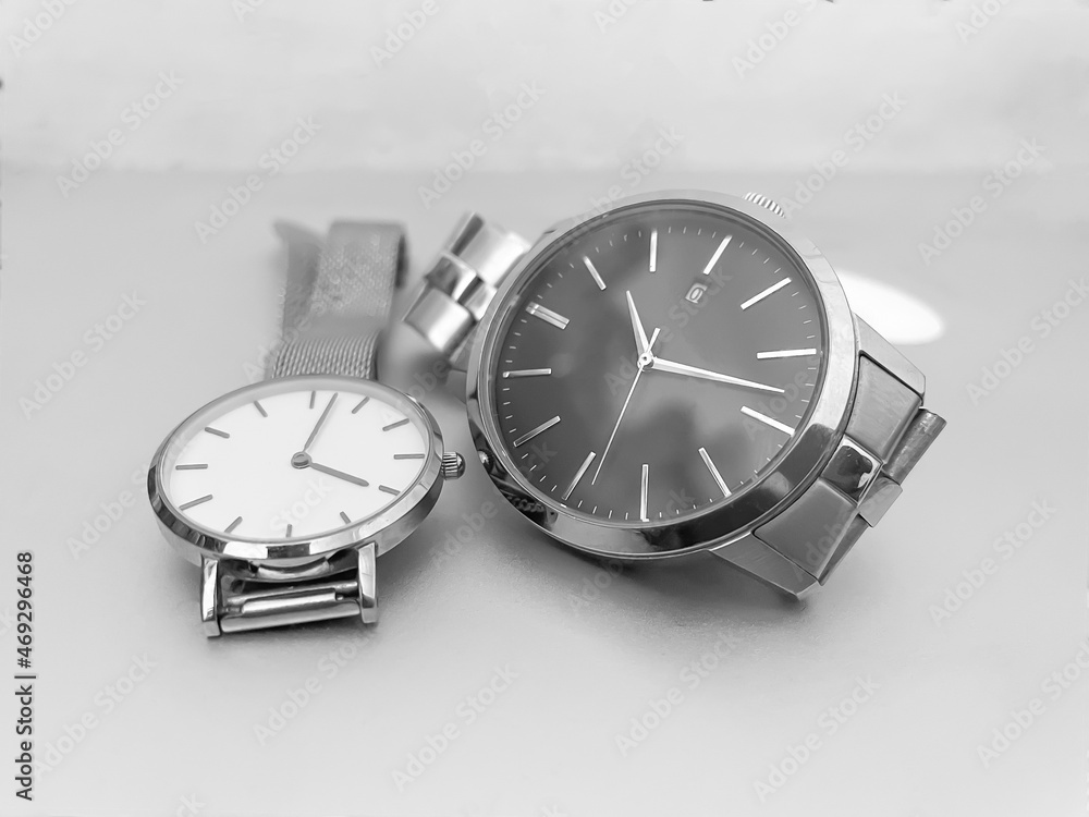 men and woman watch on grey background men and woman watch on grey background