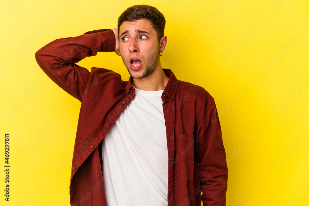 Young caucasian man with tattoos isolated on yellow background being shocked, she has remembered important meeting. Young caucasian man with tattoos isolated on yellow background being shocked, she has remembered important meeting.