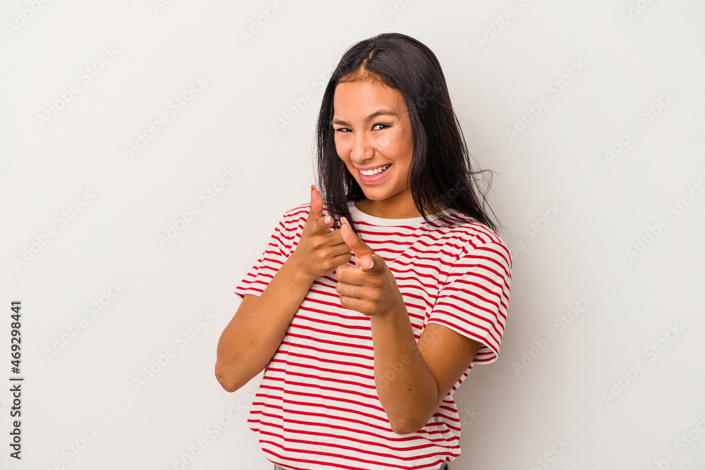 Young latin woman isolated on white background pointing to front with fingers. Young latin woman isolated on white background pointing to front with fingers.
