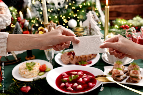 Fotografia Sharing with Christmas Eve wafer at the festive table
