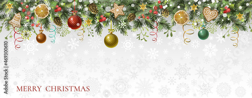 Christmas holiday background with fir branches, gingerbread cookies, orange slices, holly berry and Christmas balls. Postcard.
