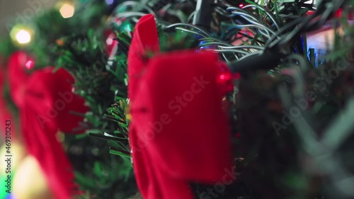 Christmas multicolored garland is lit beautifully. New Year's light on a green branch. Video, footage for screensaver, intro, presentation, transition, congratulations, effects. UHD 4K. photo