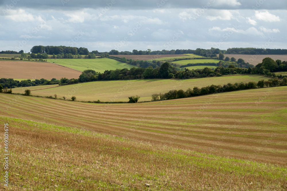 View over arable landscape with stubble field in foreground, East Garston, West Berkshire, England, UK