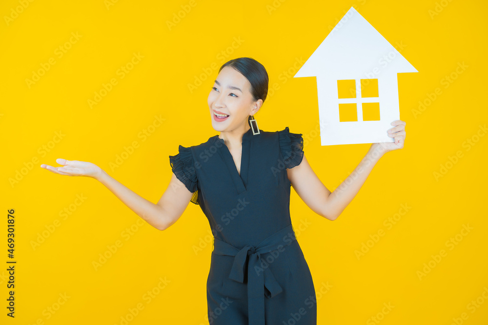Portrait beautiful young asian woman with house or home paper sign Portrait beautiful young asian woman with house or home paper sign