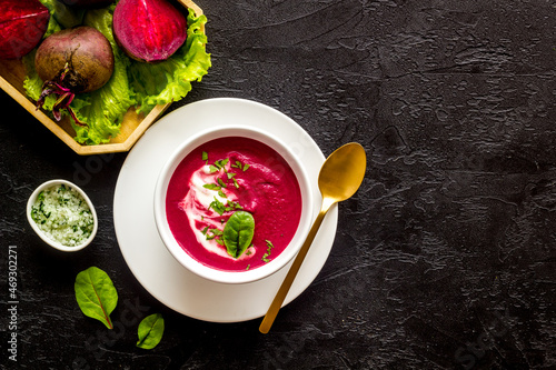 Cream soup made of red beet with raw beet roots