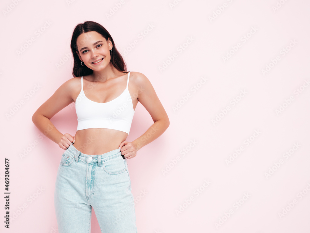 Young beautiful smiling female in trendy summer clothes. Sexy carefree woman posing near pink wall in studio. Positive brunette model having fun and going crazy. Cheerful and happy Young beautiful smiling female in trendy summer clothes. Sexy carefree woman posing near pink wall in studio. Positive brunette model having fun and going crazy. Cheerful and happy