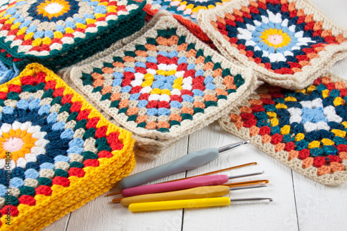 Handmade granny squares and assorted crochet hooks