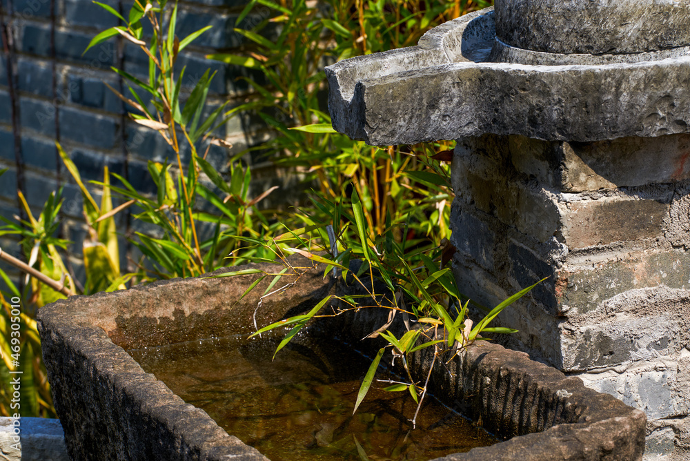 Stone mill running water pool in Chinese classical garden Stone mill running water pool in Chinese classical garden