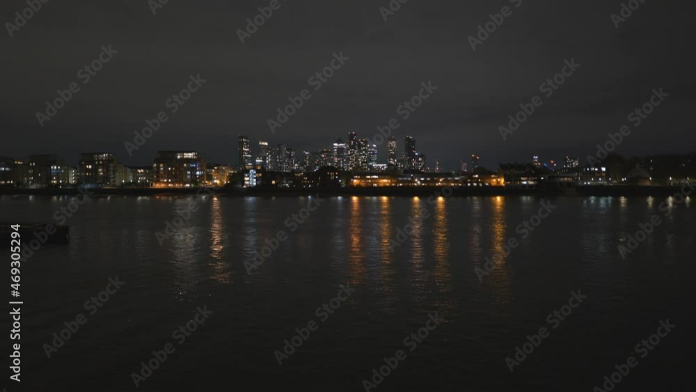 A night view of Canary Wharf across Thames River. A night view of Canary Wharf across Thames River.