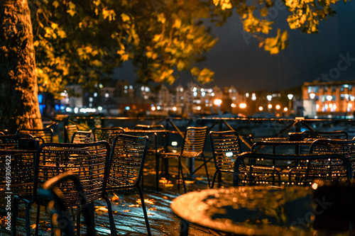 Valokuvatapetti City cafe terrace near the river in the rainy autumn evening in the lantern light