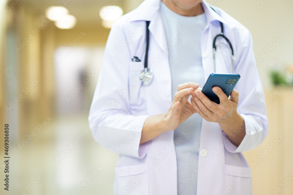 Portrait Caucasian elder woman medical doctor working and using smart phone in hospital Healthcare and medical concept. Portrait Caucasian elder woman medical doctor working and using smart phone in hospital Healthcare and medical concept.