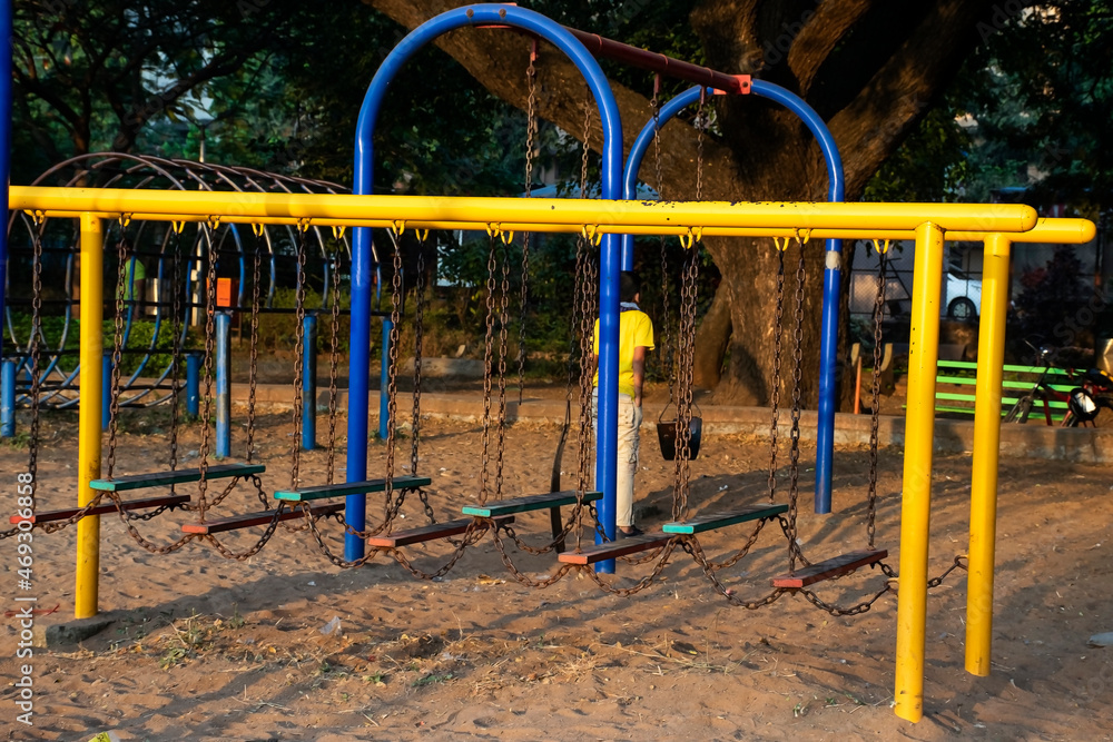 Stock photo of yellow and blue color painted climbing adventure equipment for kids, Picture captured at Rankala lake Kolhapur , Maharashtra, India. amusement concept. childhood memories.