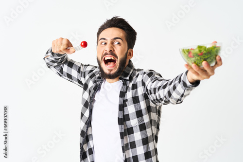 emotional bearded man in plaid shirt plate with salad