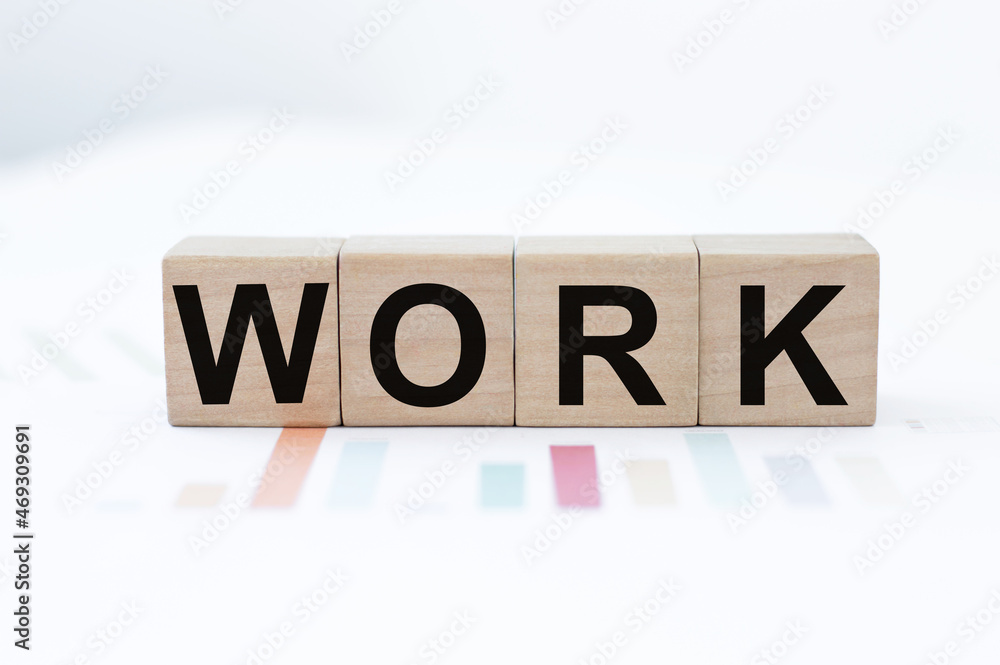Wooden block cube with alphabet text WORK on wood table. education working information. business job concept. Wooden block cube with alphabet text WORK on wood table. education working information. business job concept.