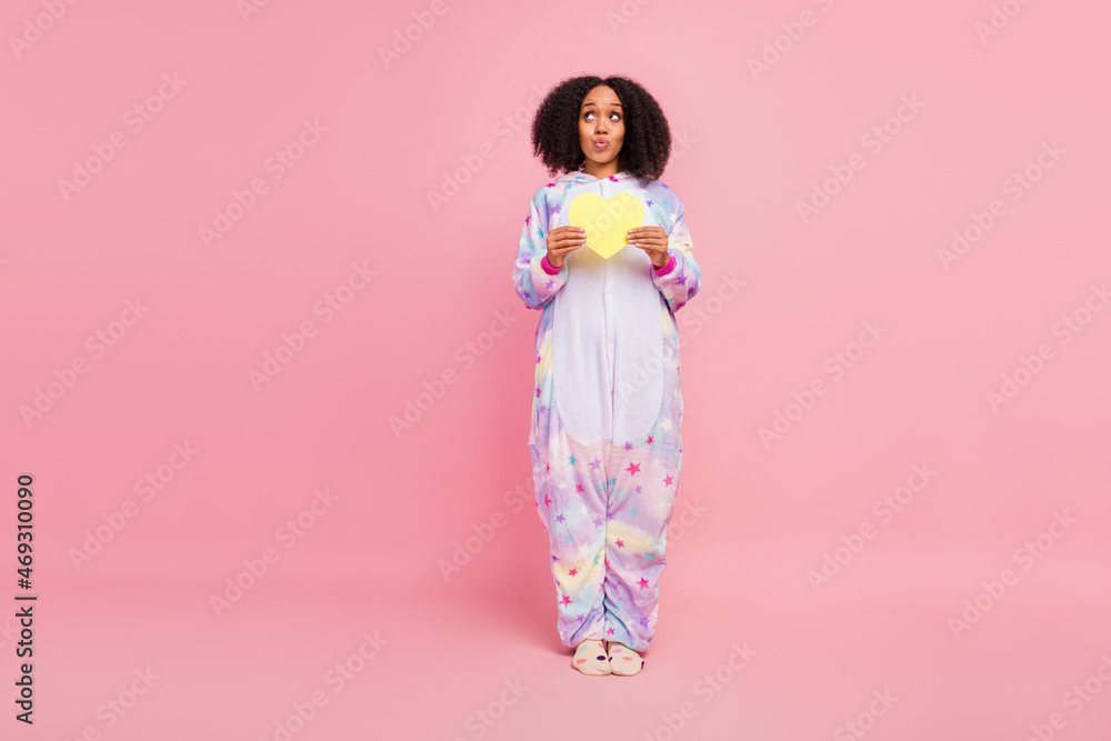 Full size photo of young african girl wondered look empty space plump lips feelings heart isolated over pink color background