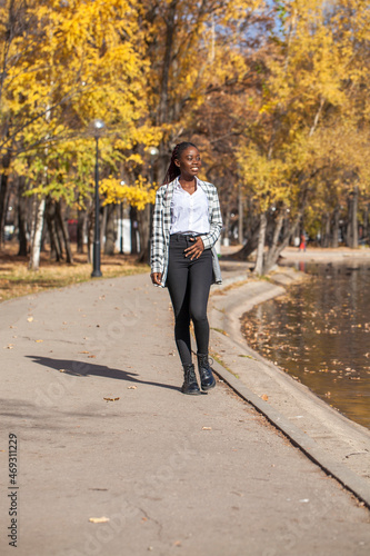 Young beautiful brunette woman posing in autumn park © Andrey_Arkusha