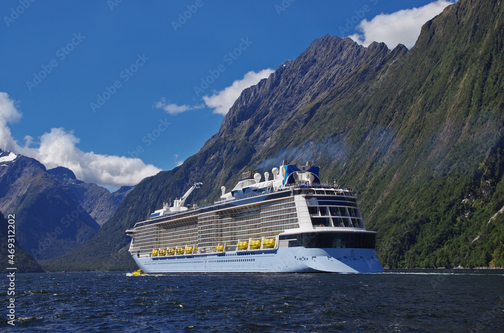 Majestic Milford Sound and a big touristic ship. New Zealand landmark. Cruising in Fjordland. Majestic Milford Sound and a big touristic ship. New Zealand landmark. Cruising in Fjordland.